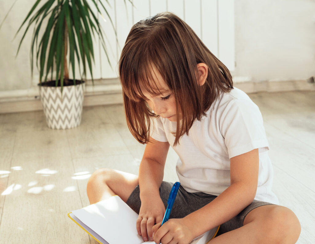 Attentive kid using laptop at home for learning and fun